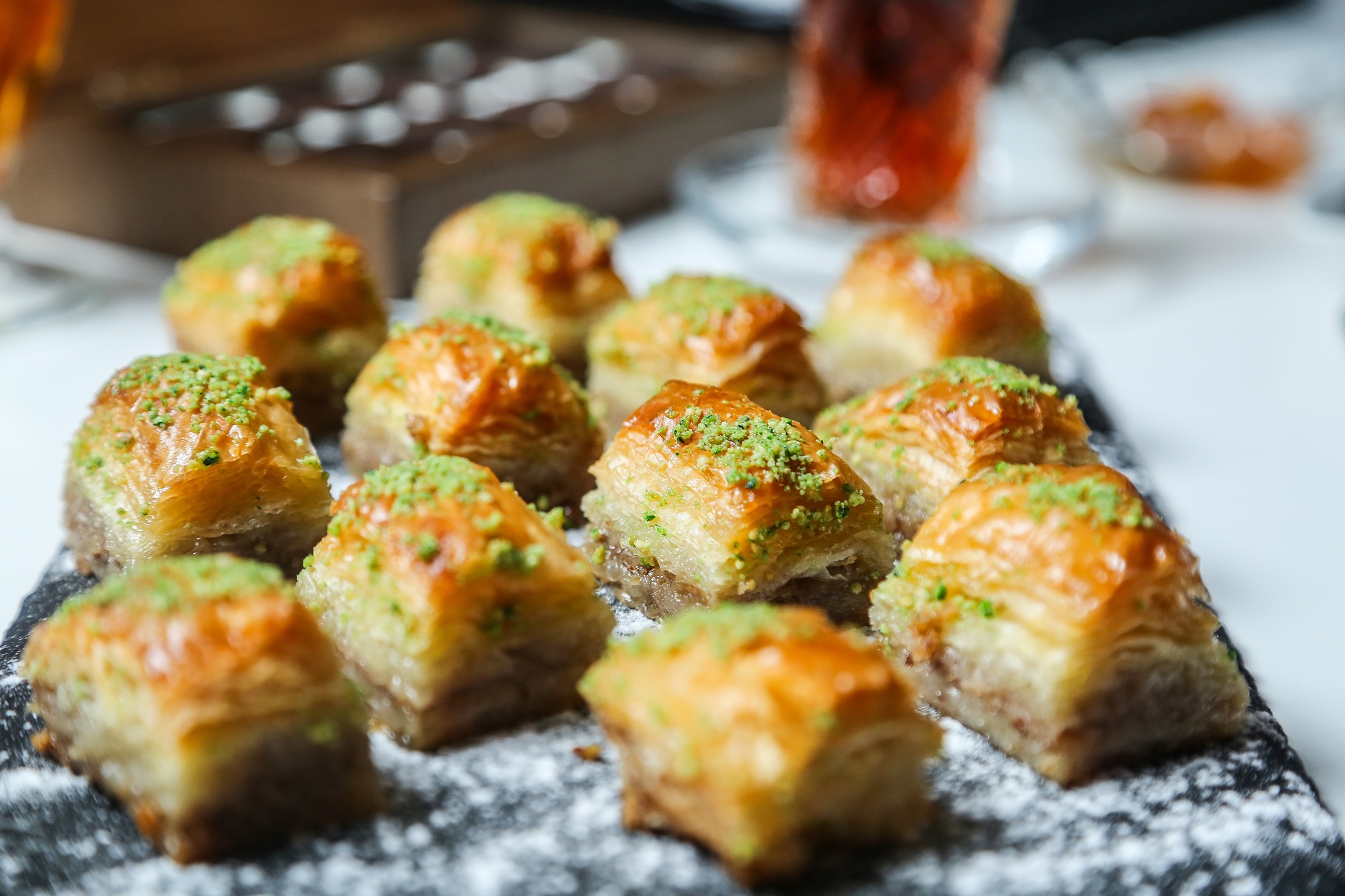 side view traditional turkish baklava with pistachios on a stand